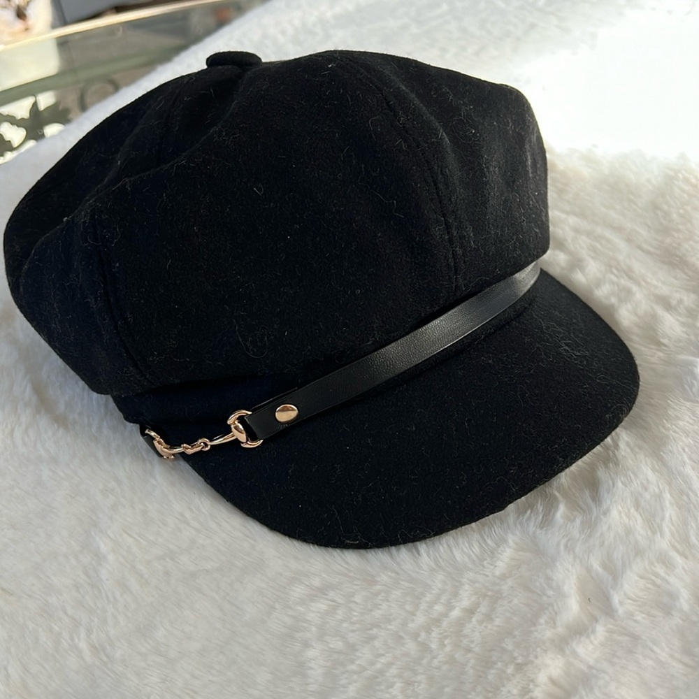 Woman’s black buckled trim cap. 100% polyester. Very nice shape.